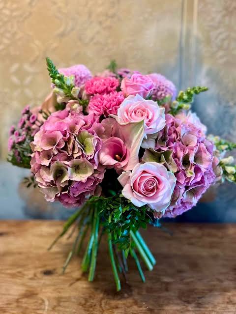Hand-tied bouquet of pink hydrangeas, roses and calla lilies